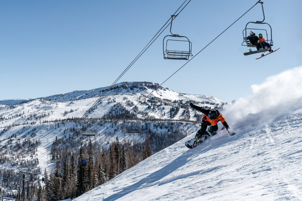 Brian Head resort mountain peak and snowboarder riding terrain