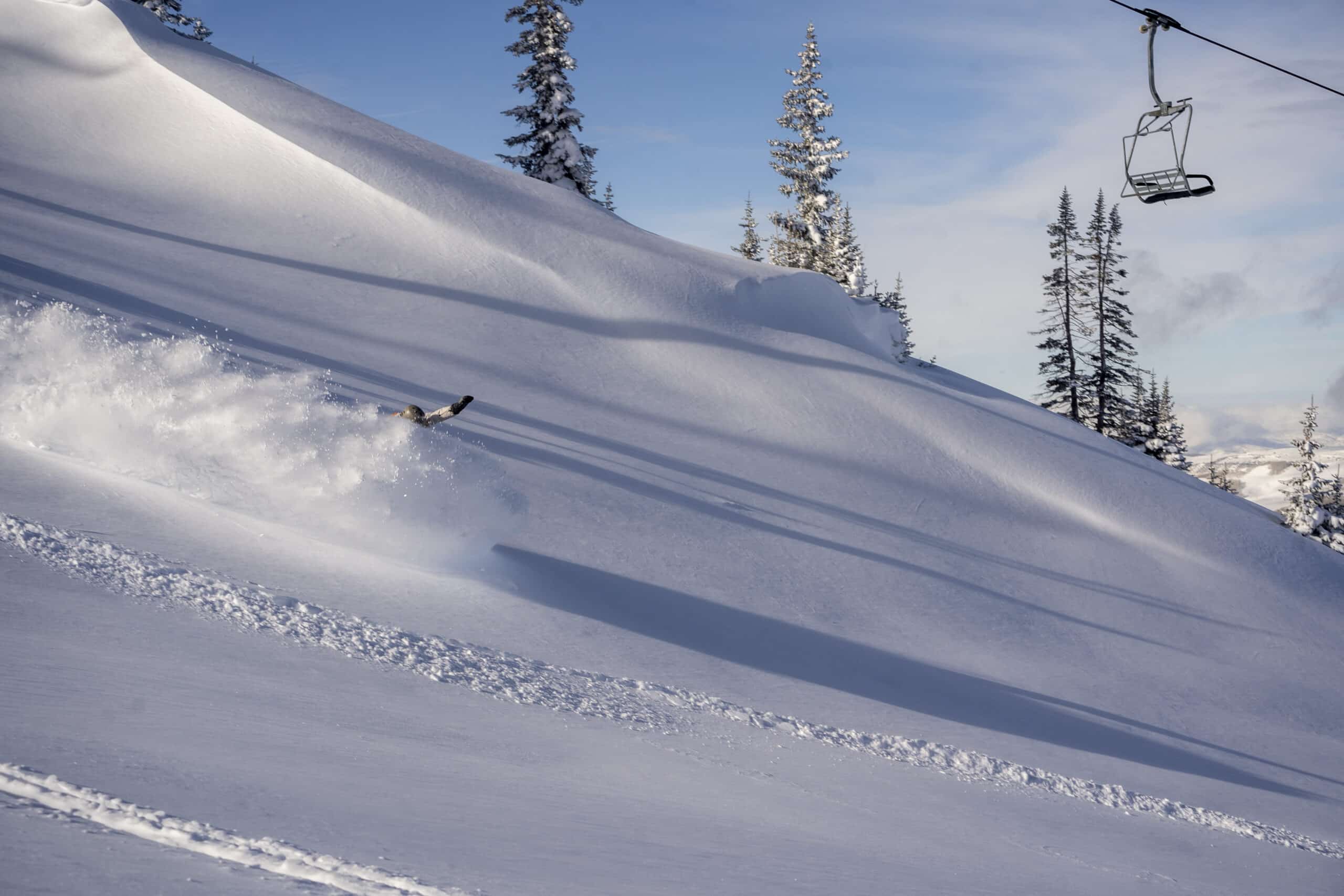 snowboarder in deep powder at Brian Head Resort