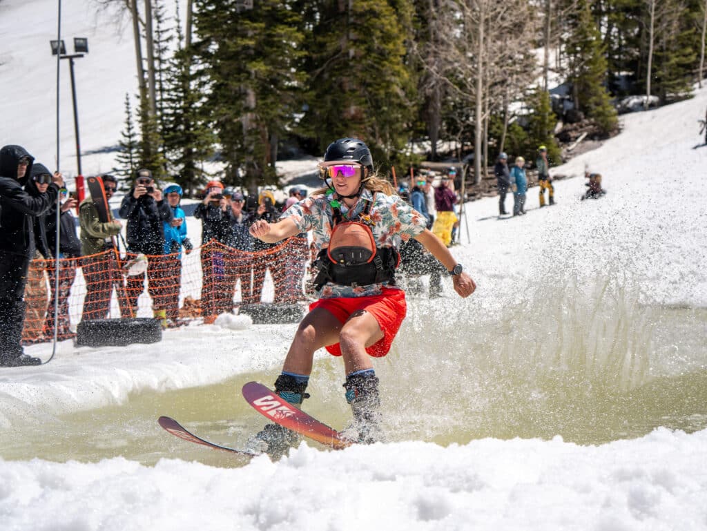 Skier skimming across the pond during the Brian Head Pond Skim Spring Carnival event.
